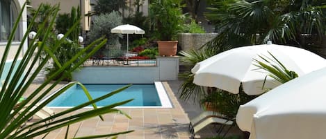 Seasonal outdoor pool, open 7:30 AM to 9:30 PM, pool umbrellas