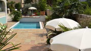 Seasonal outdoor pool, pool umbrellas, pool loungers