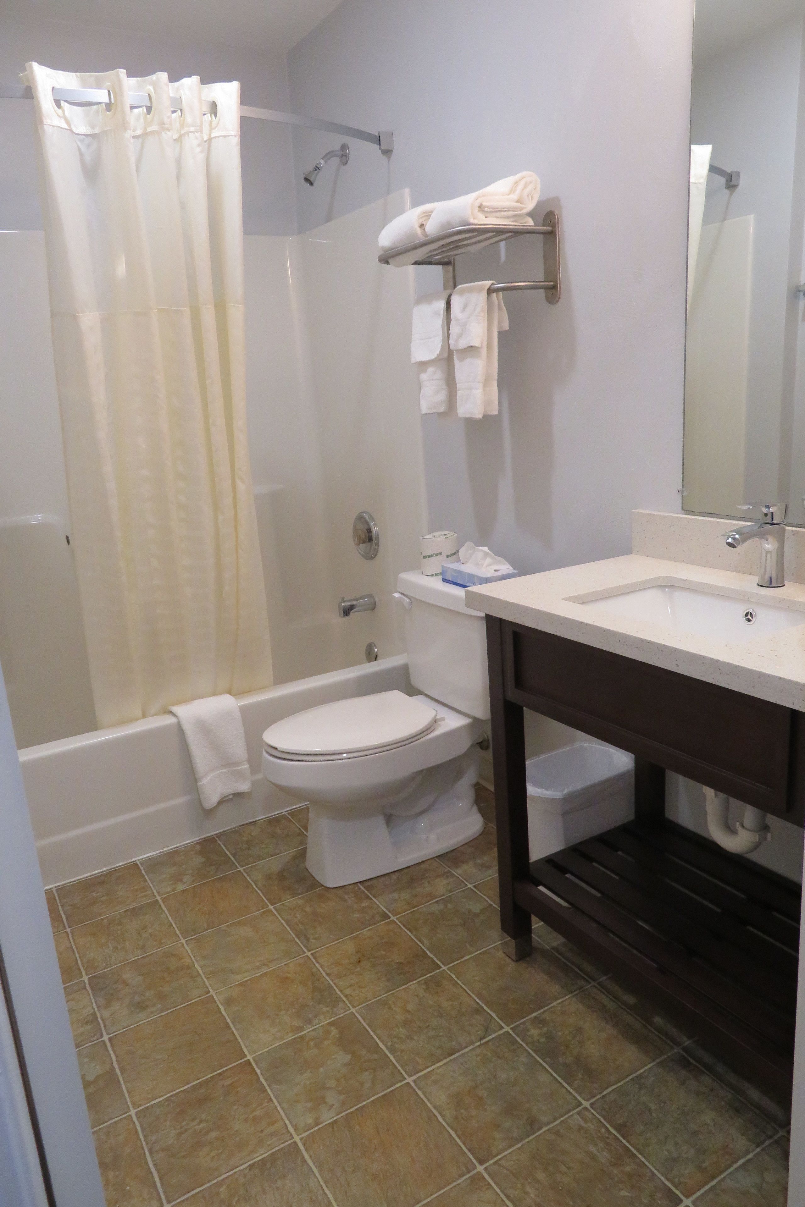A bathroom with a bathtub, toilet, and sink.