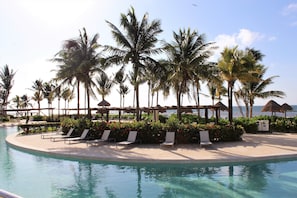 On the beach, white sand, sun loungers, beach umbrellas
