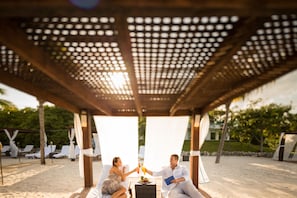 On the beach, white sand, sun loungers, beach umbrellas