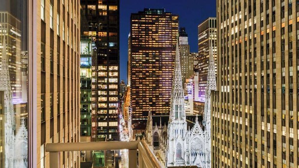 A cityscape with modern high-rise buildings and a historic building with intricate architecture. - Manhattan Centre Hotel (New York)