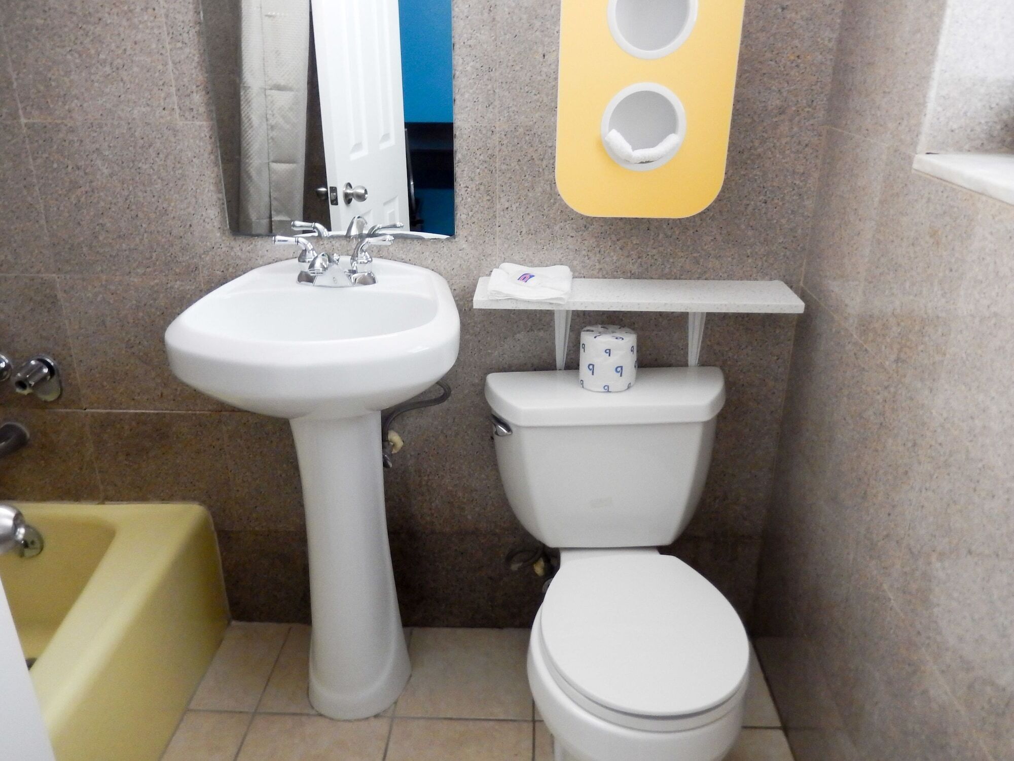 A bathroom with a white sink, toilet, and bathtub.