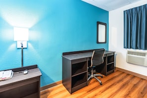Desk, laptop workspace, blackout drapes, iron/ironing board