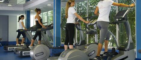 A gym with treadmills and exercise equipment.