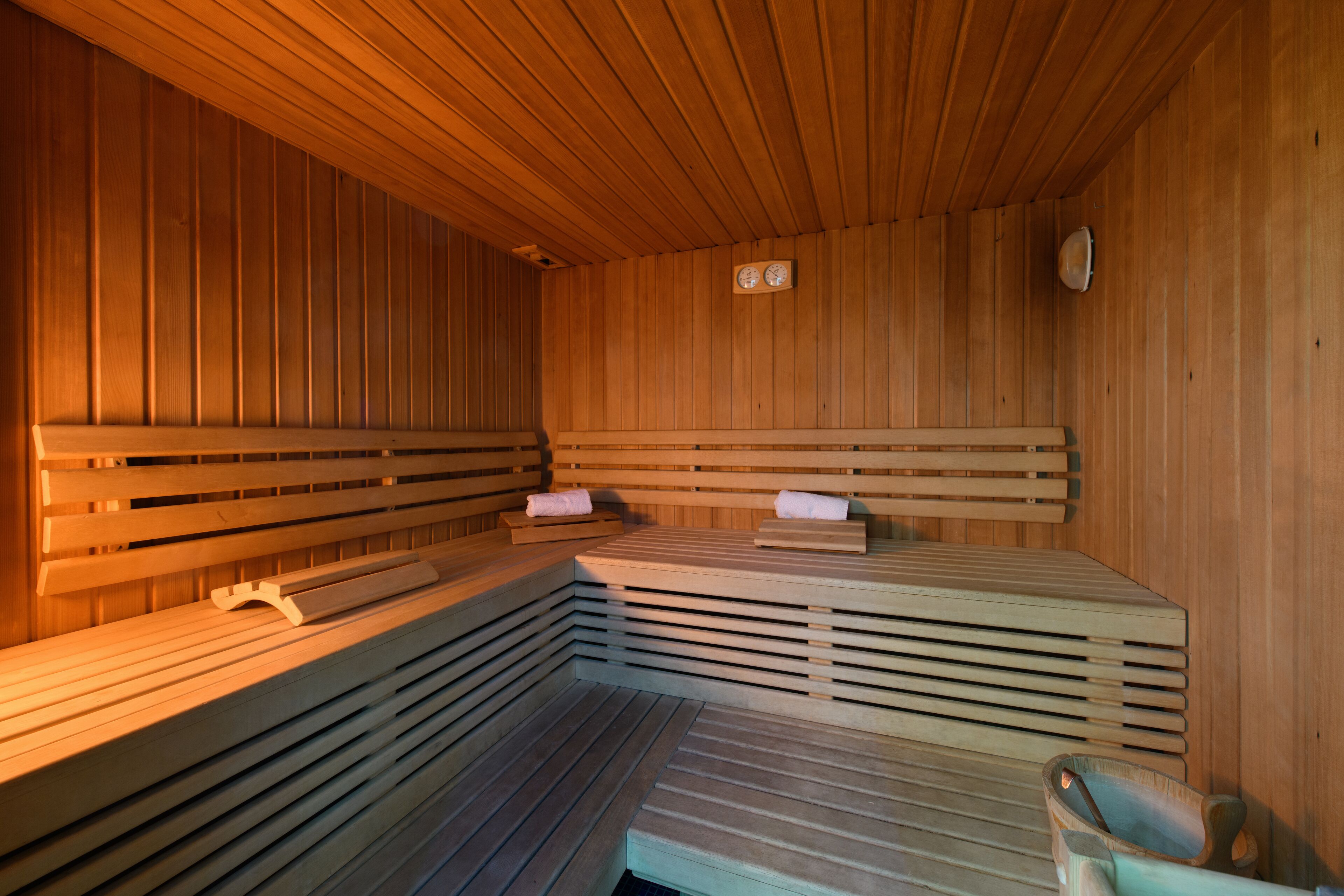 A sauna with wooden benches and a bench seat.