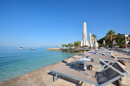 Private beach, white sand, sun loungers, beach umbrellas