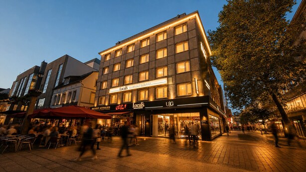A multi-story hotel with a ground floor restaurant and a visible storefront. - Locals Stadthotel Bielefeld (Bielefeld)