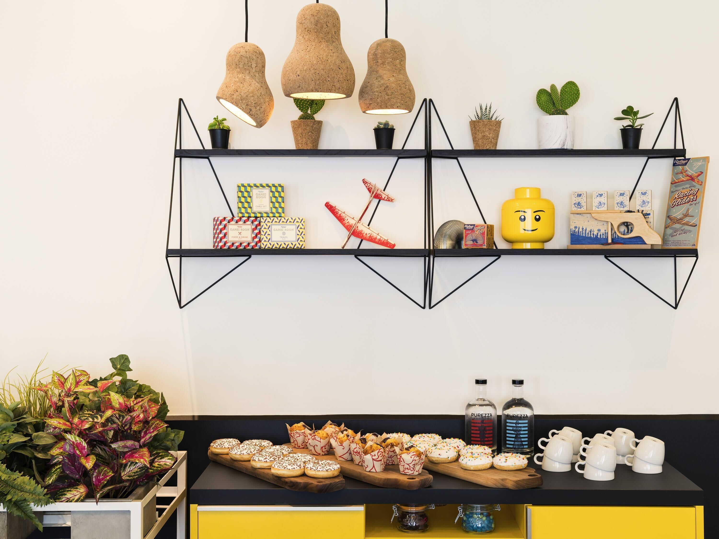A wall-mounted shelf with books, a toy, and a board game.
