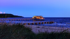 A wooden pier extending into the water with a building at the end. - Hotel Skansen Båstad (Bastad)
