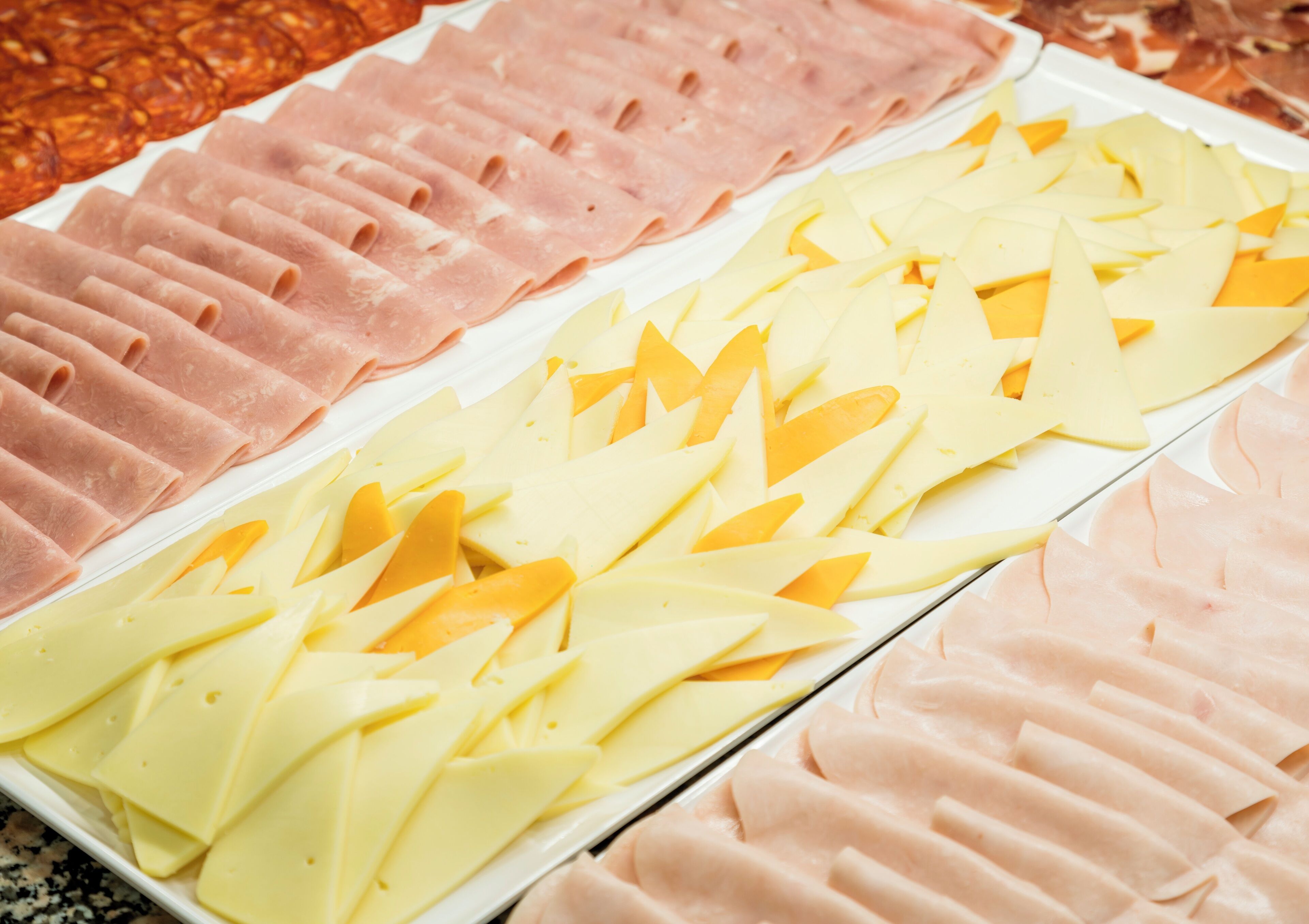 A platter of sliced meats and cheeses.