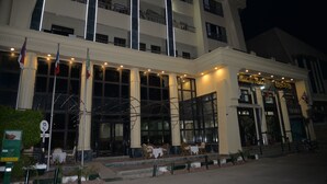 A multi-story hotel with a grand entrance, large windows, and flags. - Marhaba Hotel Aswan (Aswan)