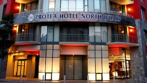 A modern hotel with multiple balconies and a prominent entrance.