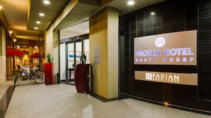The exterior of Protea Hotel North Wharf with a sign for Fabian Architects.