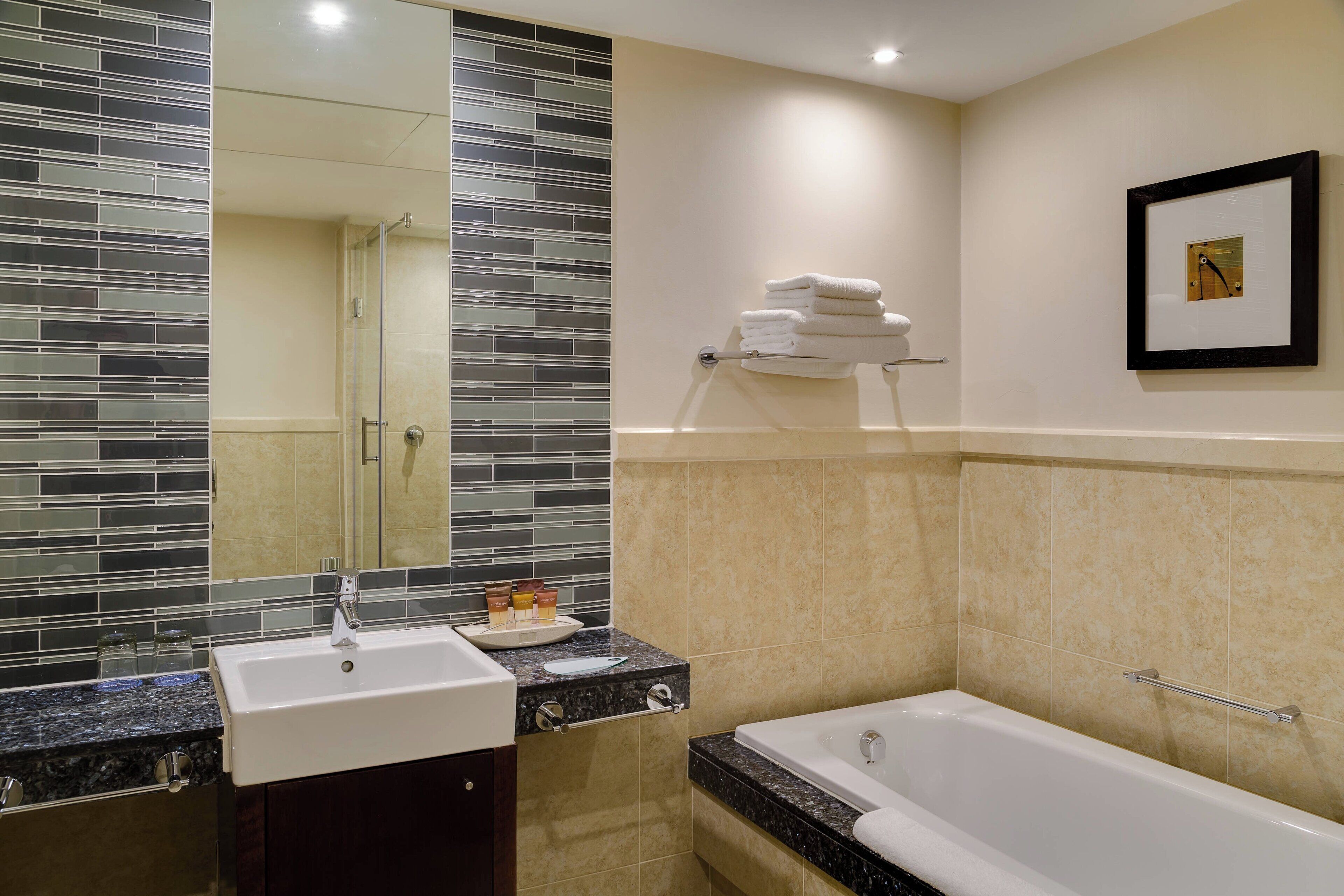 separate bathtub and shower, hair dryer, towels, soap