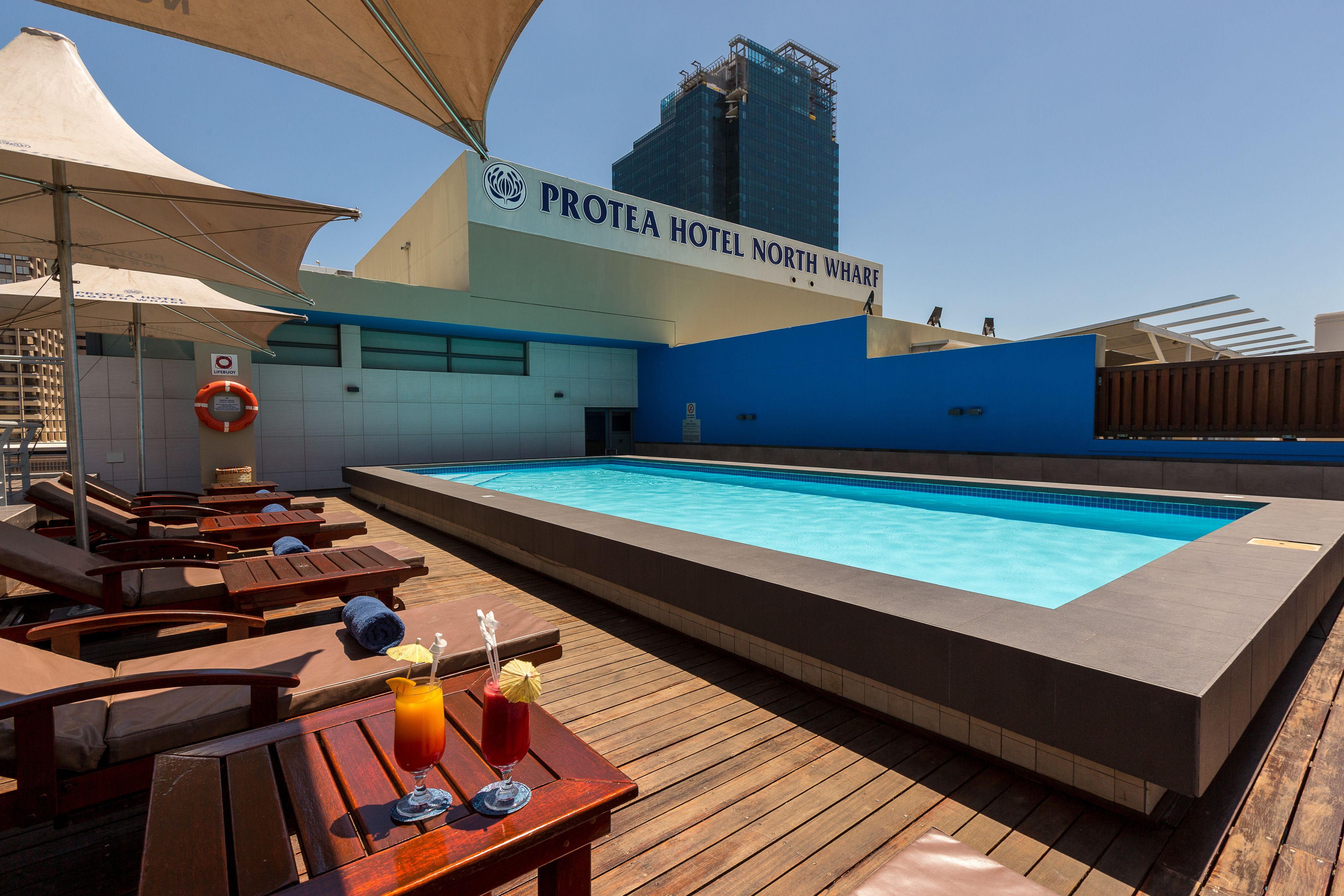 outdoor pool, open 8:00 am to 6:00 pm, pool umbrellas, pool loungers