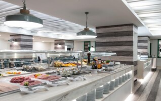 A buffet setup with various food items and condiments.