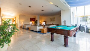 A spacious living area with a pool table, comfortable seating, and large windows. - MS Vila Nova (Ponta Delgada)