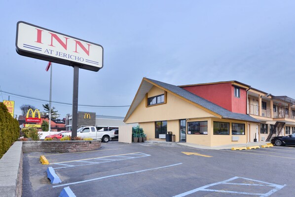 A motel with a sign reading "INN AT JERICHO," a parking lot, and a McDonald's restaurant in the background.