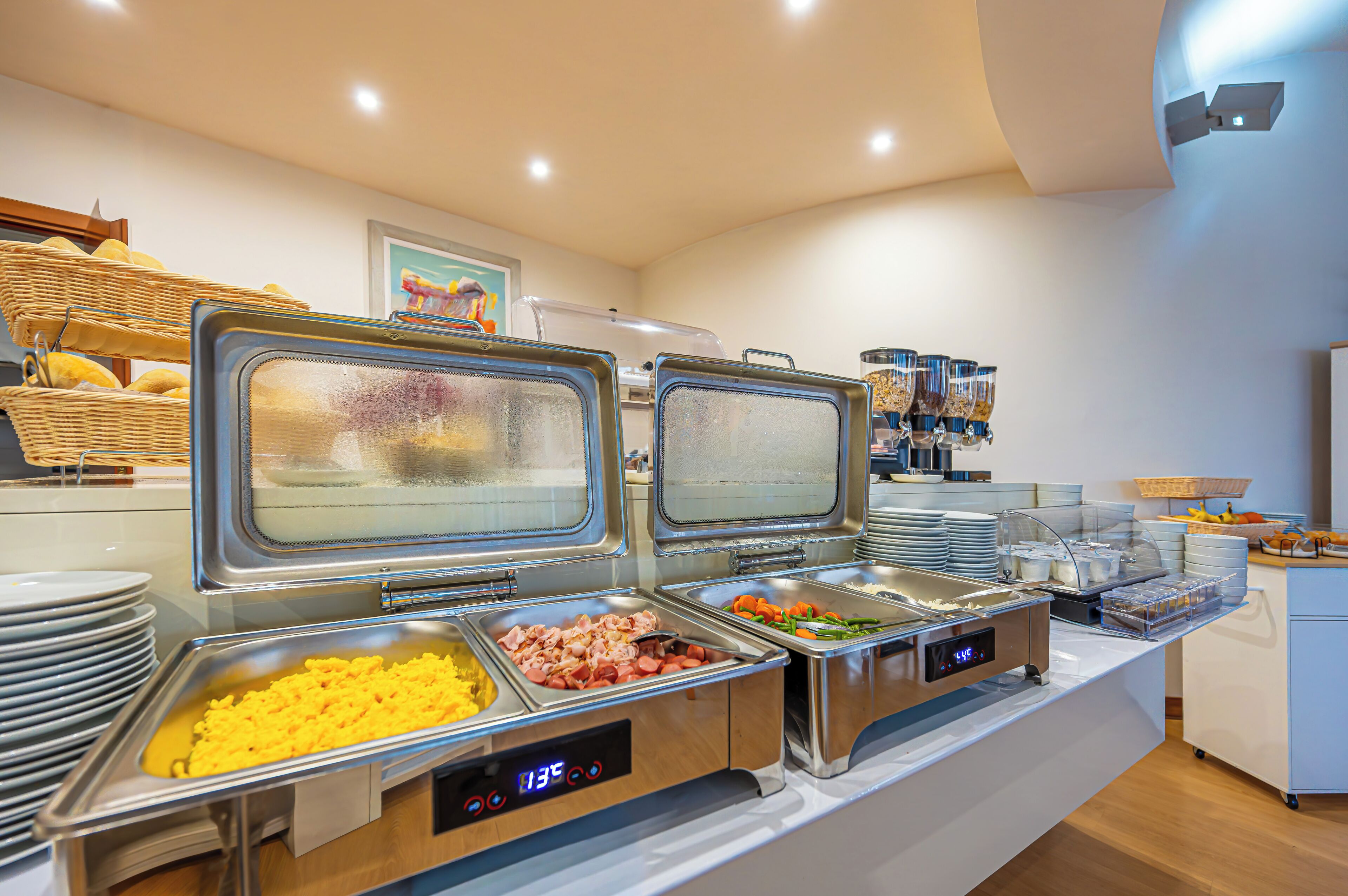 A buffet with various food options, including meats, vegetables, and grains.