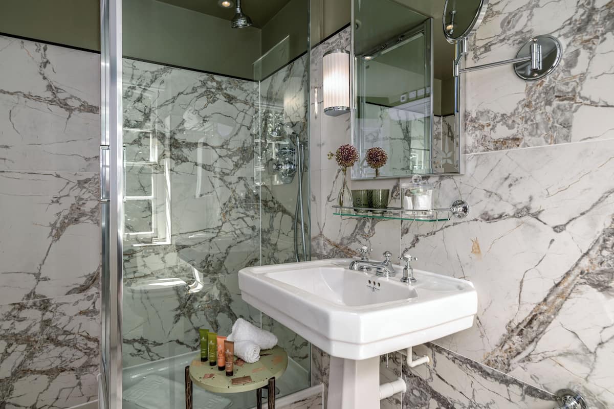 deluxe room | bathroom | shower, designer toiletries, hair dryer, bathrobes