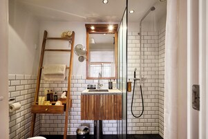 Shower, designer toiletries, hair dryer, slippers