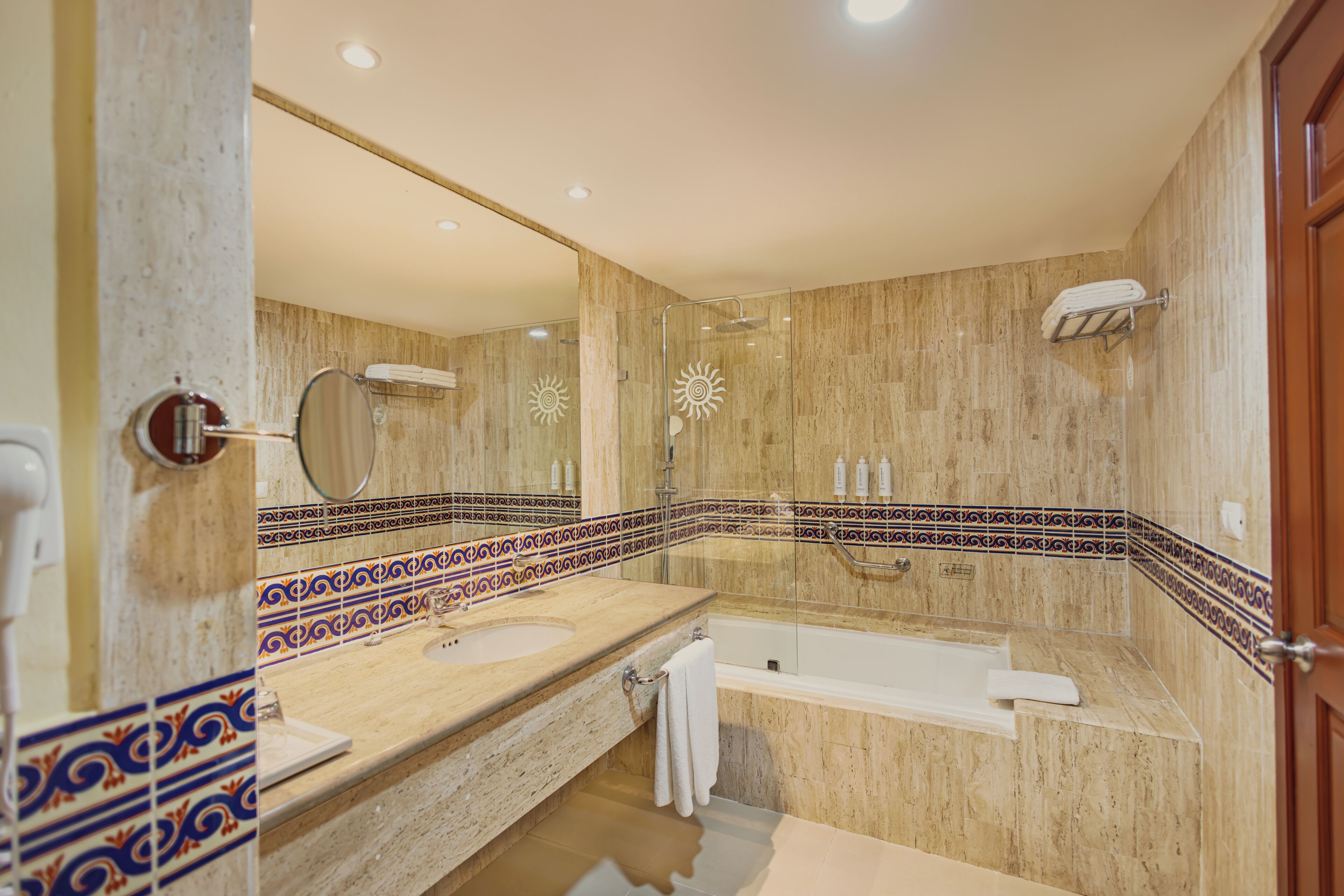 A bathroom with a double sink, a bathtub, and a shower.
