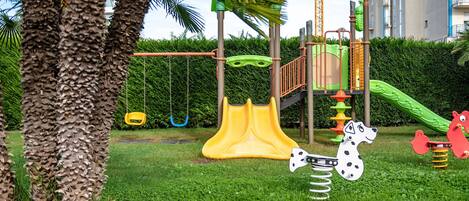A playground with a slide, swings, and a climbing structure.