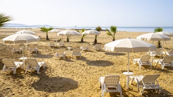 On the beach, sun-loungers, beach umbrellas, snorkelling