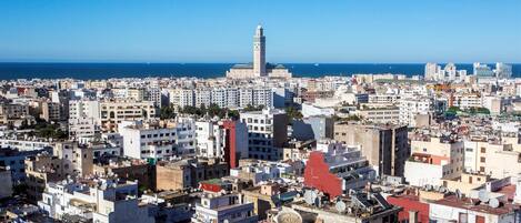 A densely packed urban area with a prominent mosque featuring a tall minaret.