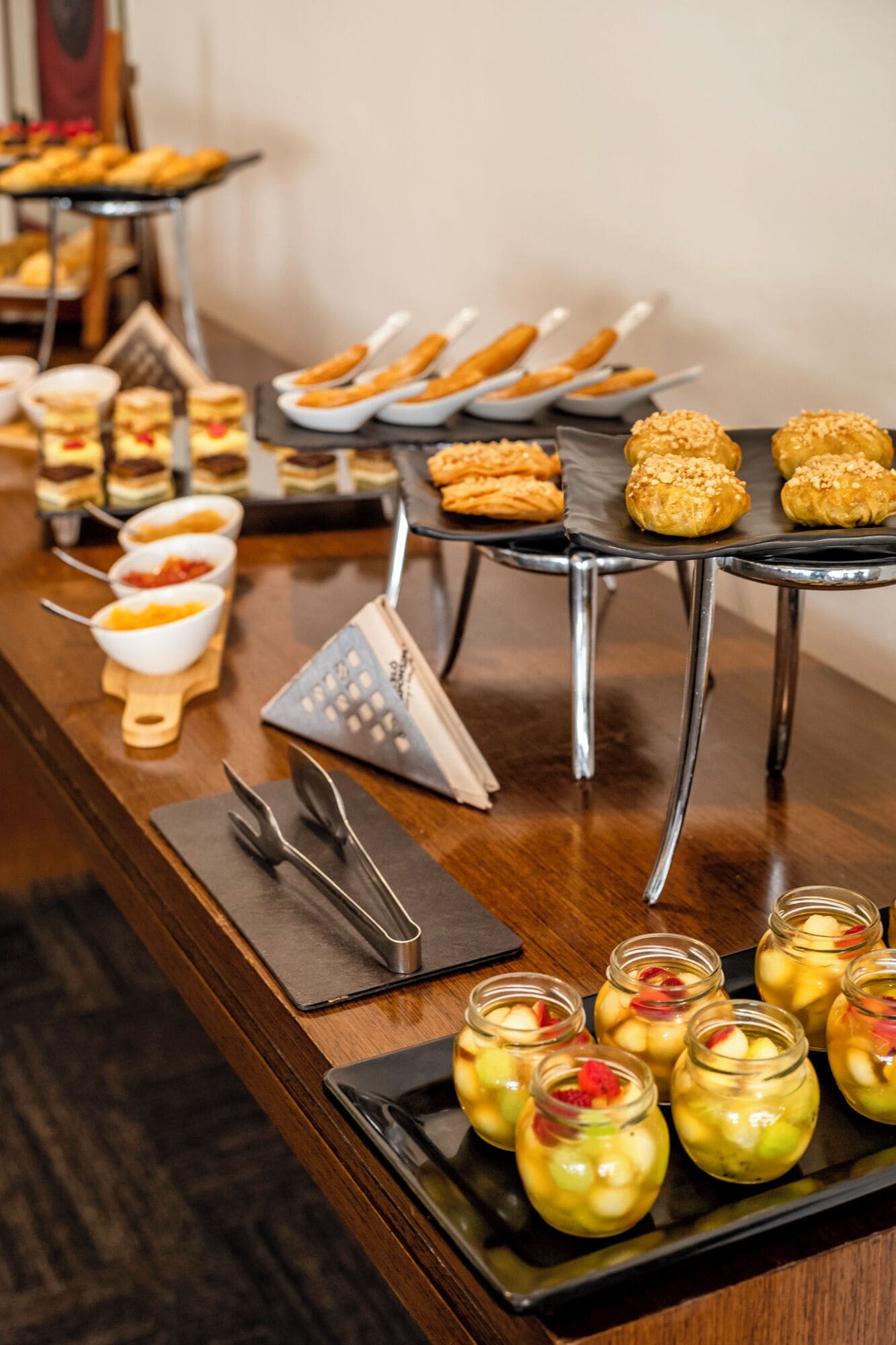 A buffet with various desserts and fruit preserves.