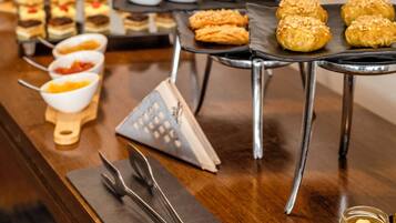 A buffet with various desserts and fruit preserves.