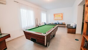 A pool table in a room with a sofa and a bookshelf. - 4U Miranda - Adults Only (Calvia)