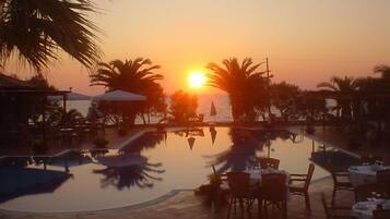 Seasonal outdoor pool, open 11 AM to 7:30 PM, pool umbrellas