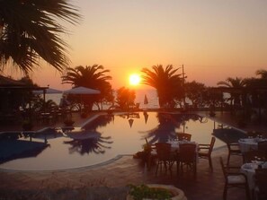 Seasonal outdoor pool, open 11 AM to 7:30 PM, pool umbrellas