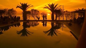 Seasonal outdoor pool, open 11 AM to 7:30 PM, pool umbrellas