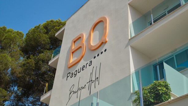 A building with a sign that reads 'BQ Paguera' and a partial view of a balcony. - BQ Paguera Boutique Hotel - Adults Only (Calvia)