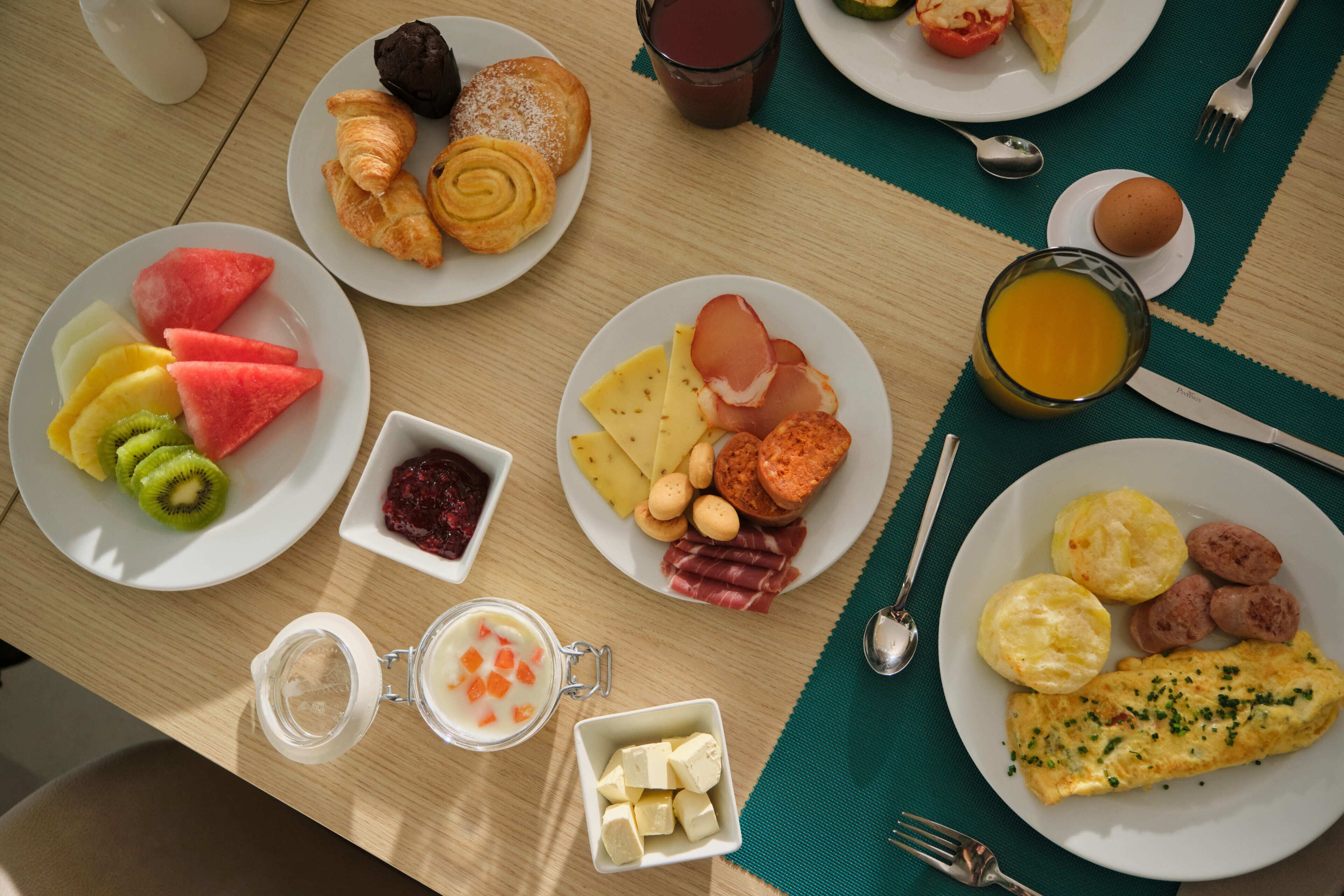 A breakfast buffet with various food items and beverages.