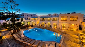 Relax by the pool surrounded by arched windows and balconies.