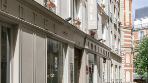 A hotel facade with large windows, a prominent 'HOTEL' sign, and a classical architectural style. - Hotel Prince Albert Wagram (Paris)
