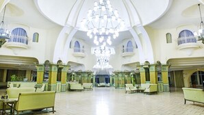 A spacious lobby with a large chandelier, seating areas, and a high ceiling. -  Mahdia beach & aquapark (Mahdia)