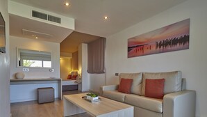 A modern living room with a sofa, a coffee table, and a painting on the wall. - BQ Augusta Hotel (Palma de Mallorca)