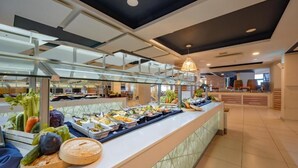 A buffet with various food items and a glass display case. - db Seabank Resort and Spa (Mellieha)