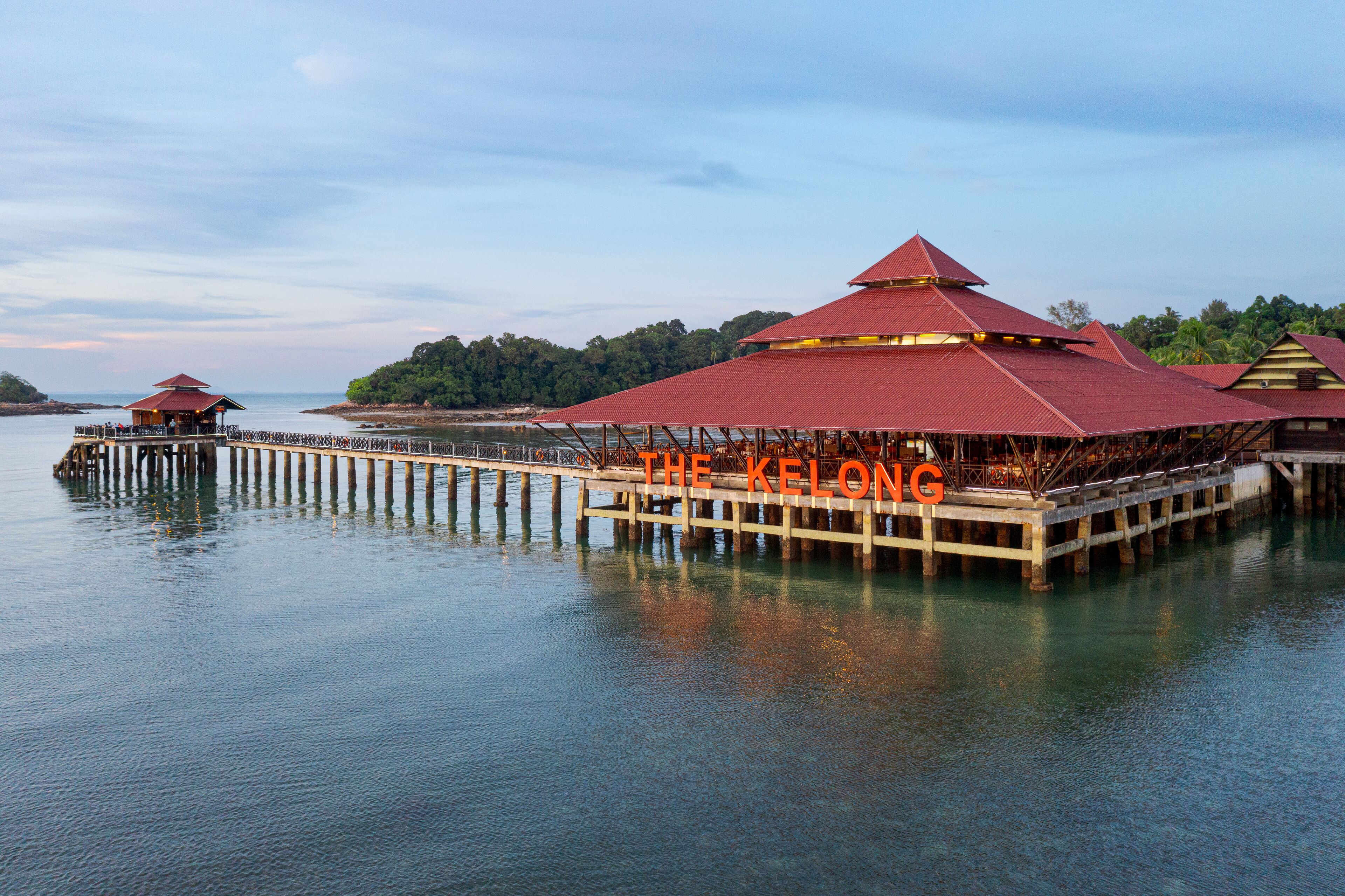 A waterfront hotel with a prominent red-roofed structure labeled "THE KELONG."