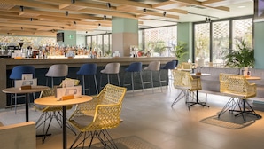 A modern bar area with seating arrangements and a counter.