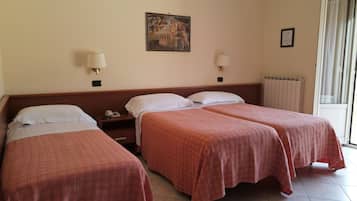A hotel room with two single beds, a nightstand with a telephone, a painting on the wall, and a window with curtains.