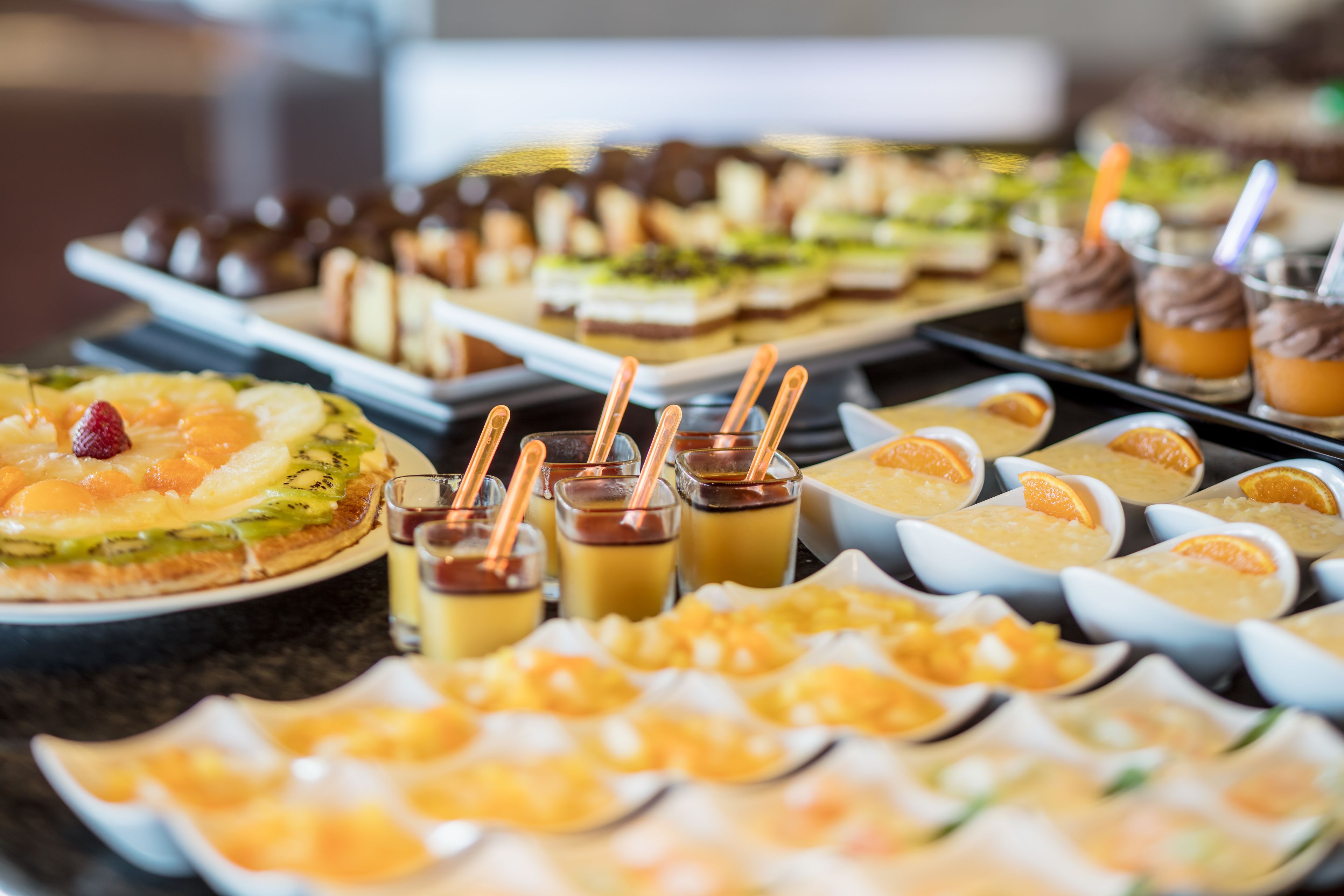 A buffet with various dishes and drinks.