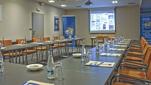 A conference room with tables, chairs, and a projection screen displaying a webpage. - EA Hotel Crystal Palace (Prague)