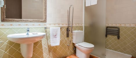 A bathroom with a sink, toilet, and shower.