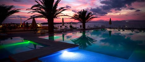 Seasonal outdoor pool, open 11:00 AM to 7:00 PM, pool umbrellas